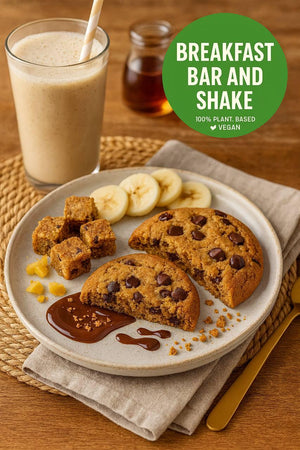 Plant-based breakfast bar, chocolate chip cookie, banana slices, and vegan shake on table