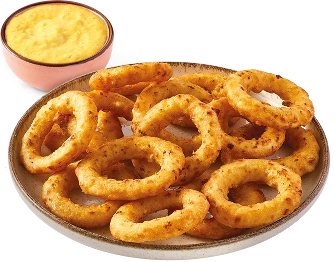 Crispy plant-based onion rings on a plate with dipping sauce from iPlantBased UAE.
