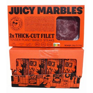 Two boxes of Juicy Marbles plant-based steaks on a white background