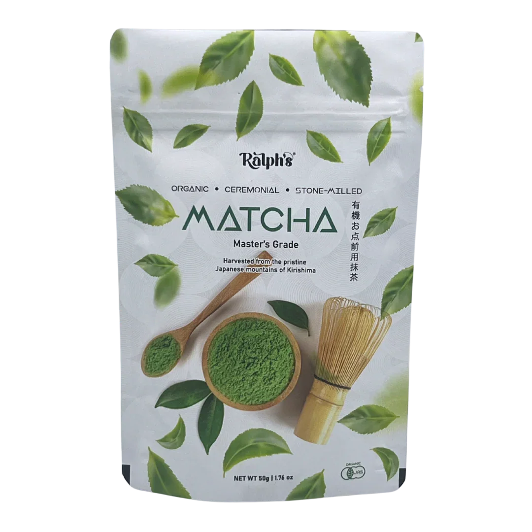 Ralph's organic ceremonial matcha powder pouch with spoon, whisk, and green tea leaves